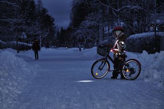Kind mit Fahrrad gut sichtbar in der Dunkelheit